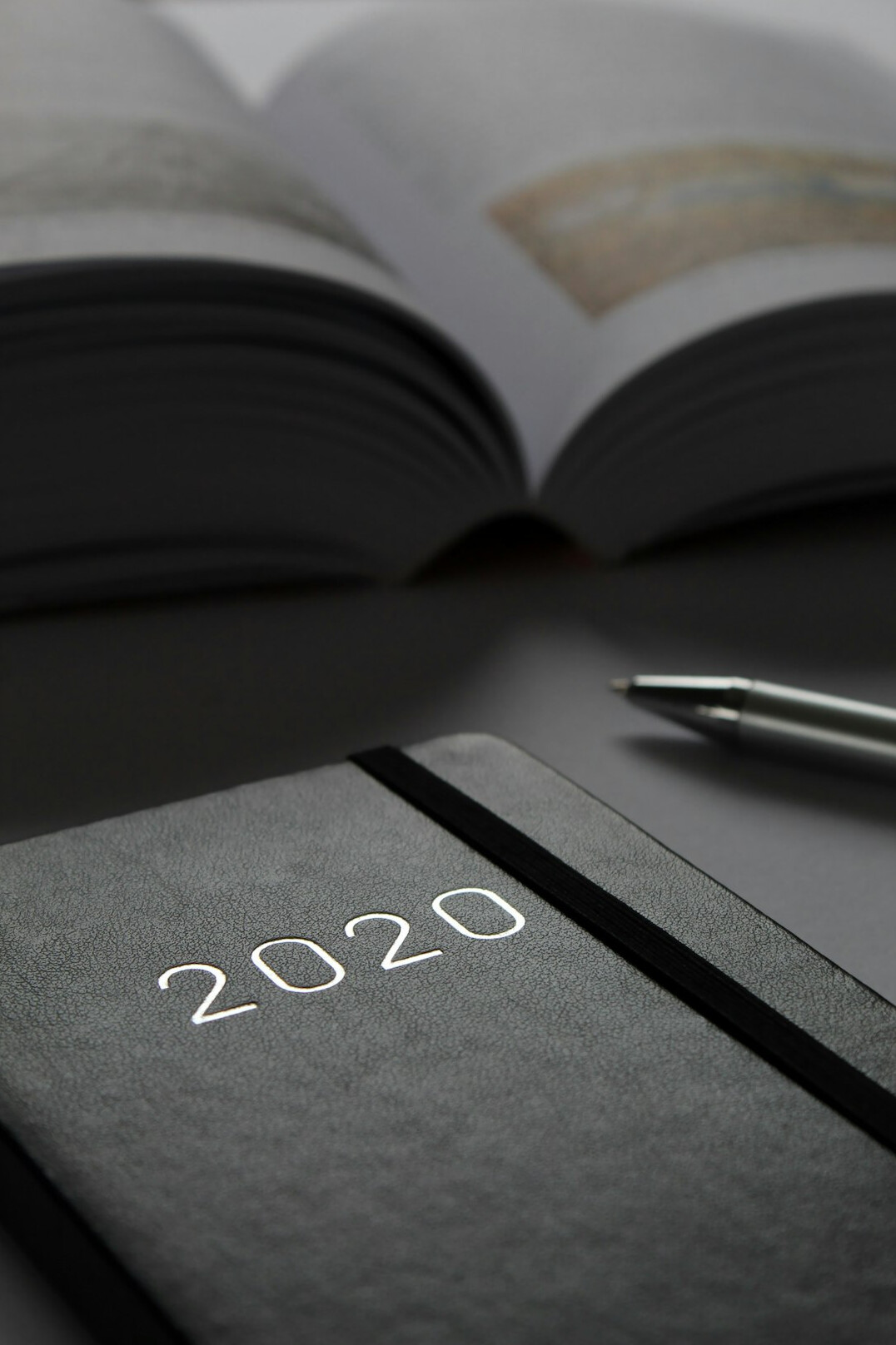 Open notebook with pen on a wooden table