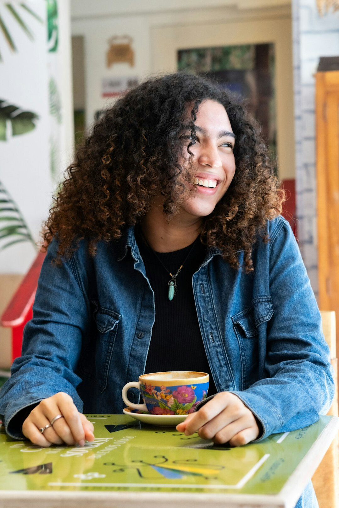 Brazilian woman smiling while writing at a desk