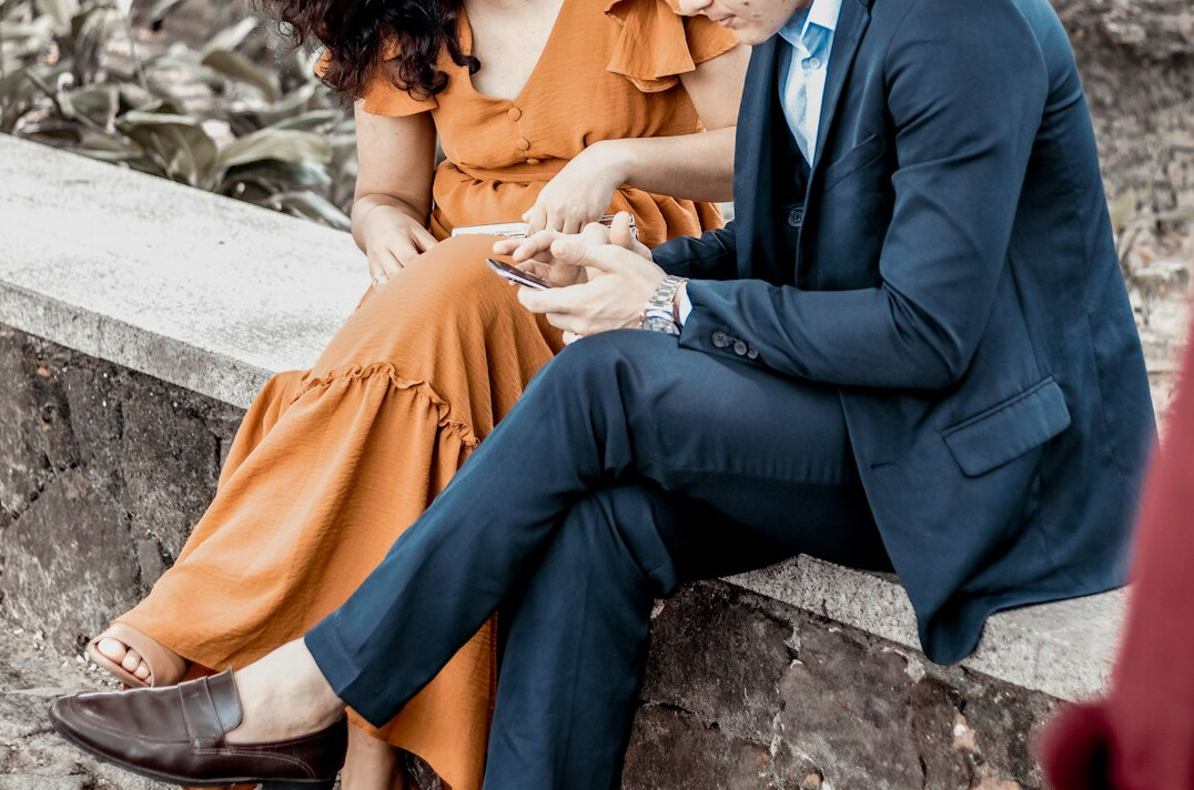 Brazilian man and woman collaborating over notes